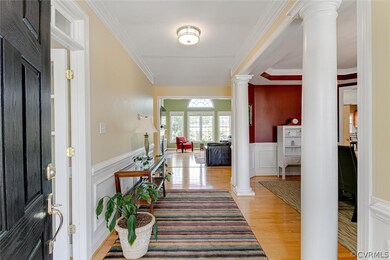 Open foyer with hardwood floors with office to lef