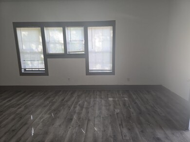 Unfurnished room with dark hardwood / wood-style f