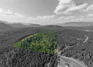 Aerial view of property's location featuring property parcel outlined and mountains