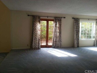 living room in between sitting area with fireplace and formal dining area