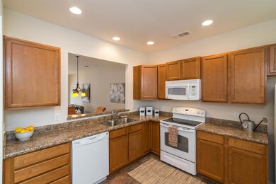 This kitchen is spacious with ample cabinets and a large pantry.