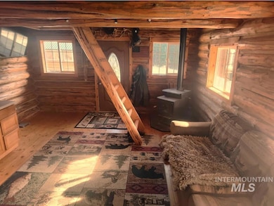 Sitting room featuring rustic walls and plenty of natural light
