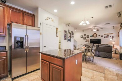 Kitchen features island, granite, pantry, stainles