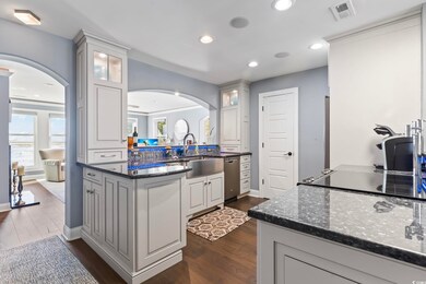 Kitchen featuring white cabinetry, kitchen peninsu
