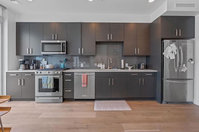 Kitchen with stainless steel appliances, a sink, 