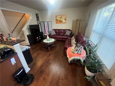 Living room with stairway and dark wood-style floo