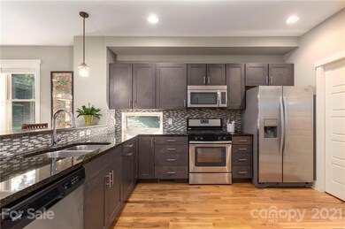 Sparkling Kitchen Features Granite Countertops, Stainless Steel, Tile Backsplash and Soft-Close Cabinets