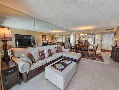 Living area with a textured ceiling, light colored