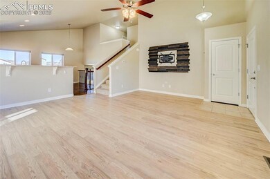 Main Level Living room featuring stairs, high vaul