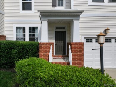 Property entrance with a porch and garage