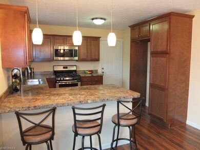 Remodeled kitchen with breakfast bar and pantry.