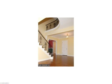 The foyer with sweeping staircase welcomes you int