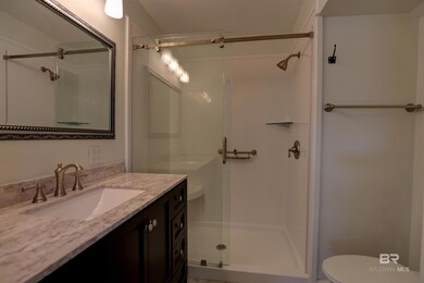 Bathroom featuring vanity, a shower, and toilet