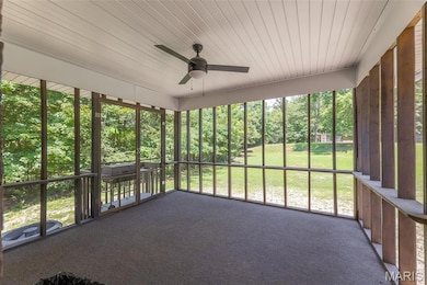 Unfurnished sunroom with ceiling fan