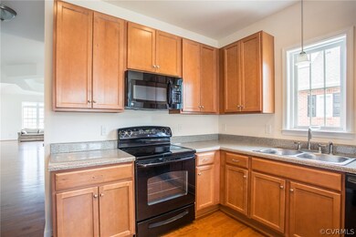Kitchen has wood cabinets (uppers are 42 inches, g