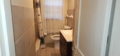 Bathroom featuring vanity, toilet, and tile patterned floors