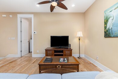 Living room with ceiling fan and hardwood / wood-s