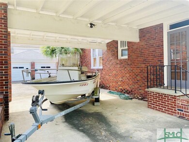Fantastic attached carport, door leading to den.