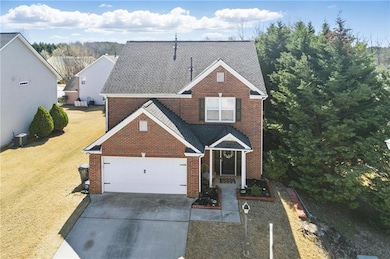 Traditional home featuring a front lawn, a garage,