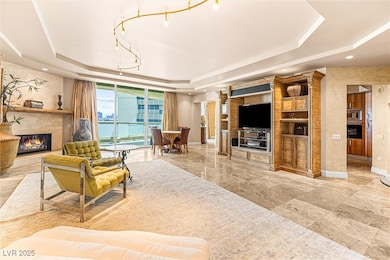Living room featuring a raised ceiling and a high