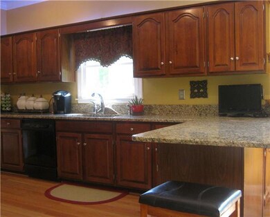 Another view showing the beautiful cabinets and plenty of them!  This home also offers a separate utility room.