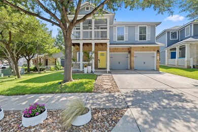 Traditional-style home with concrete driveway, a front yard, an attached garage, a balcony, and covered porch