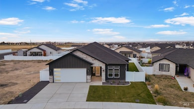 View of front of house with stone siding, driveway, board and batten siding, a residential view, and an attached garage