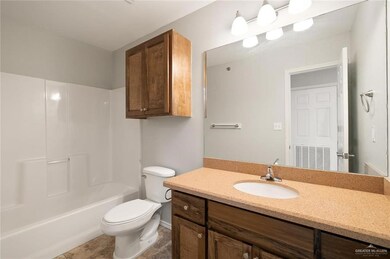 Full bathroom with vanity, tile patterned flooring, shower / bathtub combination, and toilet