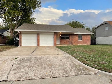 Single story home featuring a garage and a front y