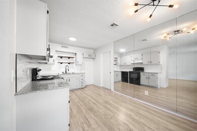 New light fixtures with freshly painted cabinets throughout