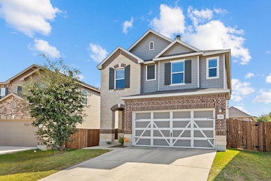 Craftsman-style house with concrete driveway, an attached garage, and brick siding