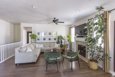 Living room with fireplace and warm wood floors
