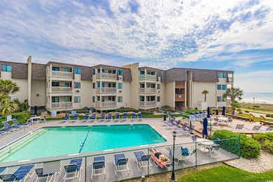Community pool with a patio and fence