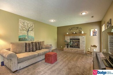 Home offers family room with brick fireplace includes gas log.  Located right off kitchen plus sliding glass door to rear lush green space and patio.