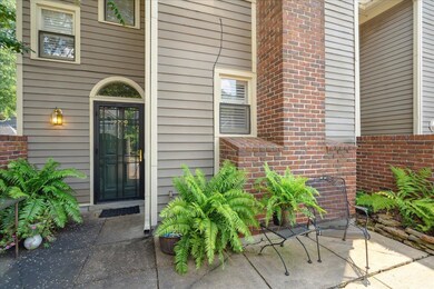 View of exterior entry with a patio