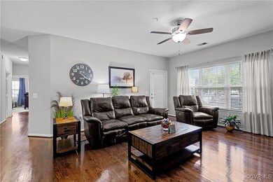 Living room with ceiling fan, dark hardwood / wood