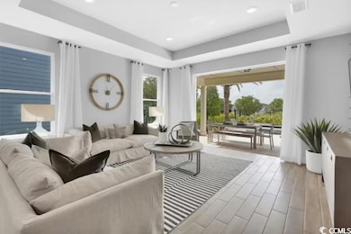 Living area featuring visible vents, recessed ligh