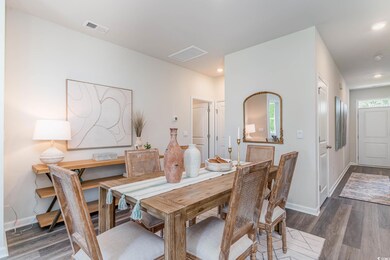 Dining space featuring visible vents, baseboards, 