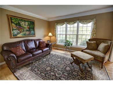 Formal living room boasts crown molding and large 