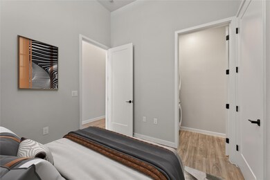 Bedroom with light wood-style floors and baseboar