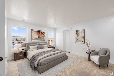 Bedroom featuring light colored carpet, multiple windows, a textured ceiling, and recessed lighting