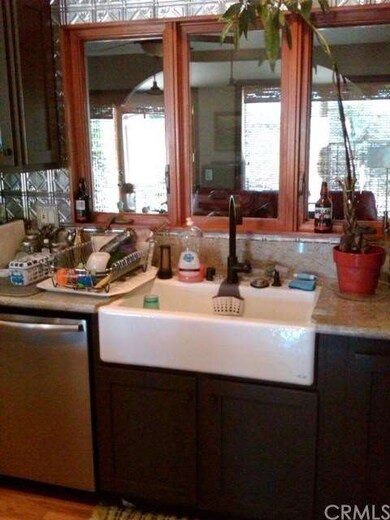 Custom kitchen has farmhouse sink, stainless appli