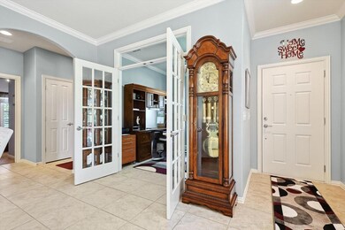 Foyer entrance with ornamental molding, light tile
