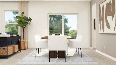 Dining space with wood finished floors and baseboards