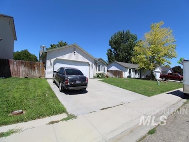 Ranch-style house featuring concrete driveway and an attached garage