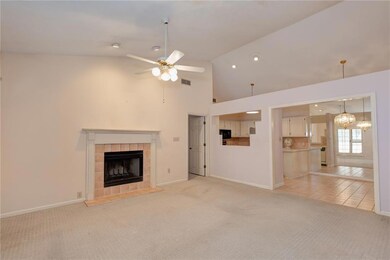 Unfurnished living room with a tile fireplace, lig