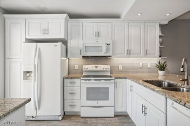 Kitchen featuring stone countertops, white cabinet