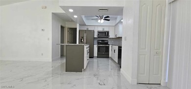 Kitchen with stainless steel appliances, white cab
