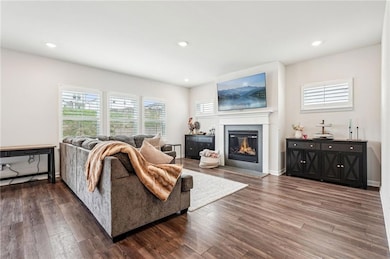 Living area with recessed lighting, dark wood fini