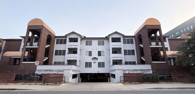 View of property with concrete driveway and an at